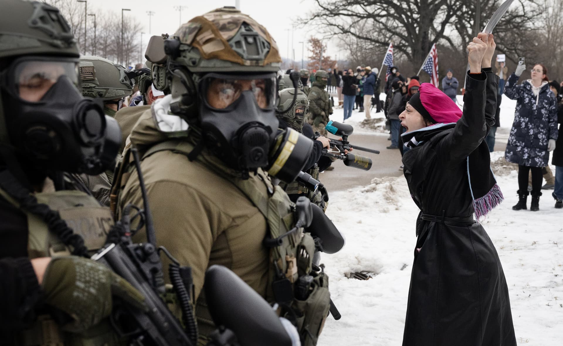 Scott Olson/Getty Images Demonstrators confront federal agents outside the Whipple federal building at Minneapolis.