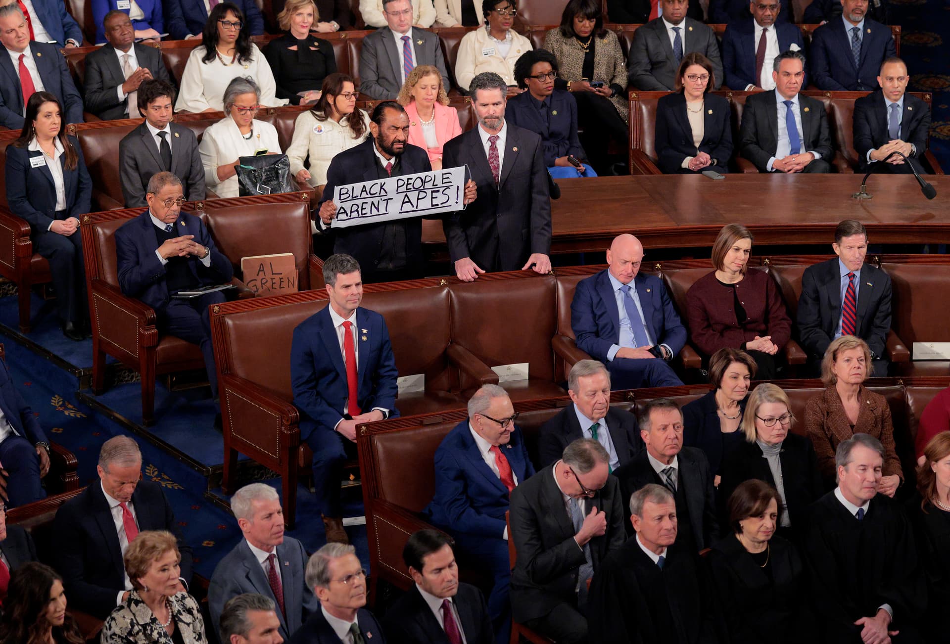 Chip Somodevilla/Getty Images Rep. Al Green holds up a sign as Trump delivers his State of the Union address during a Joint Session of Congress at the U.S. Capitol on February 24, 2026, in Washington, D.C.