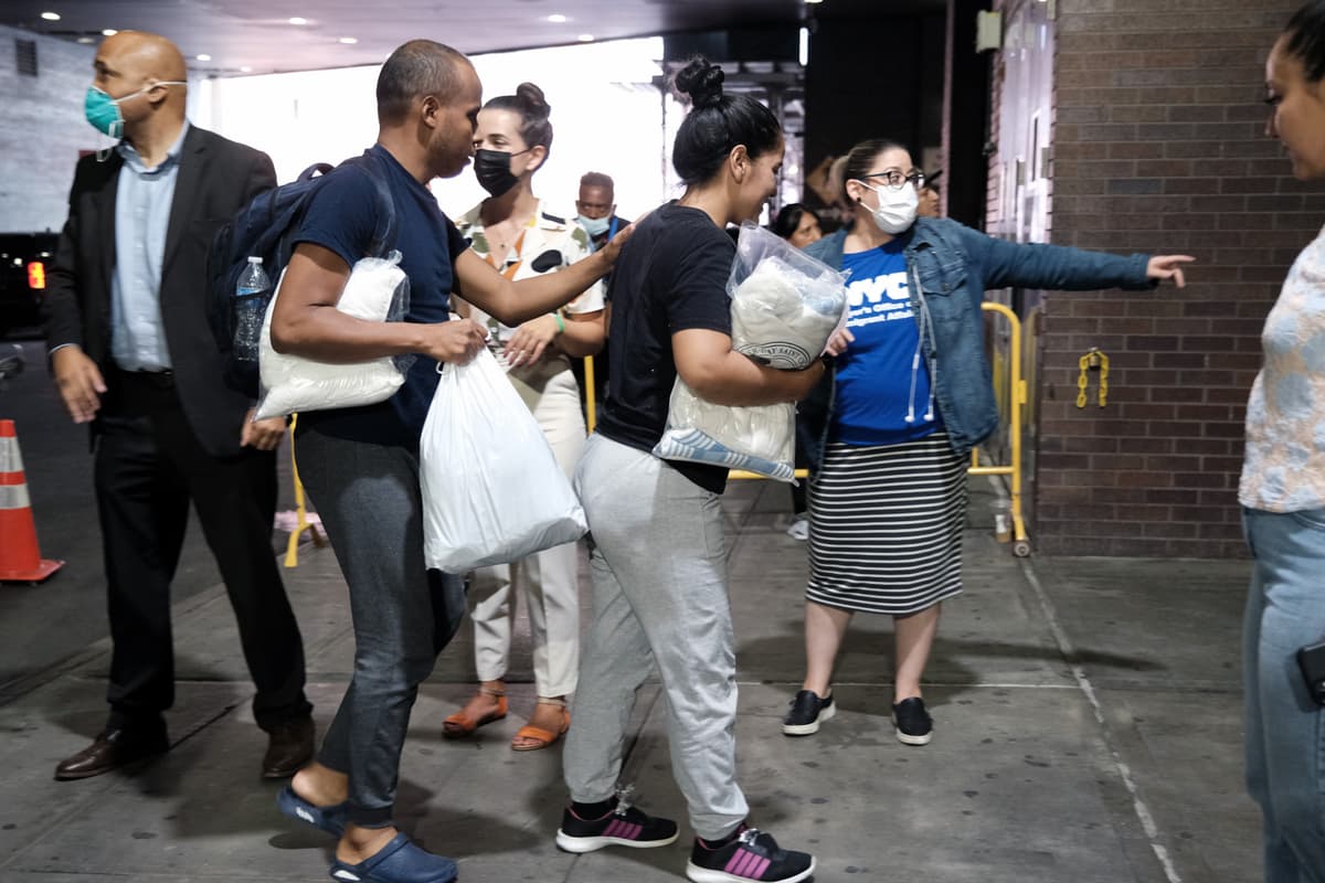 Spencer Platt/Getty Images Migrants who crossed the border from Mexico into Texas exit a bus as it arrives into the Port Authority bus station at New York City on August 25, 2022.