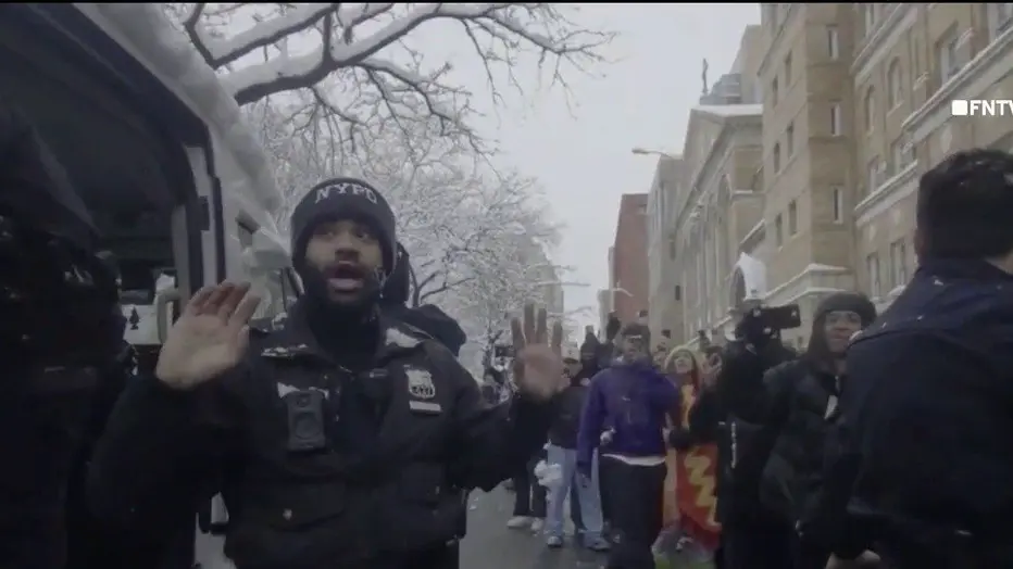 WNYW New York City Police Department officers at the scene of an attack by youth throwing snowballs.