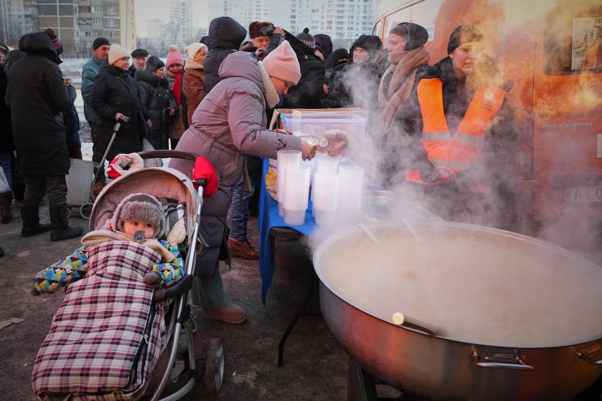 AP/Sergey Grits Yuliia Dolotova, 37, receives hot food at a distribution point during a power outage caused by Russia’s repeated air strikes on the country’s power grid, at Kyiv, Ukraine, February 2, 2026.
