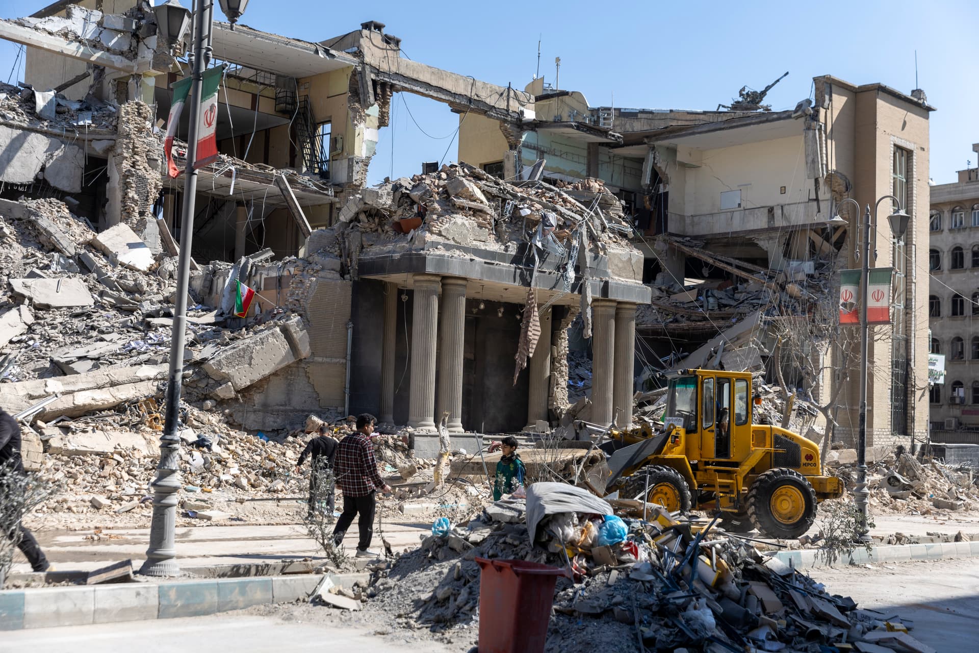 Majid Saeedi/Getty Images Cleanup continues outside a damaged building, struck days earlier, during the U.S. and Israeli military campaign on March 4, 2026 in Tehran, Iran.