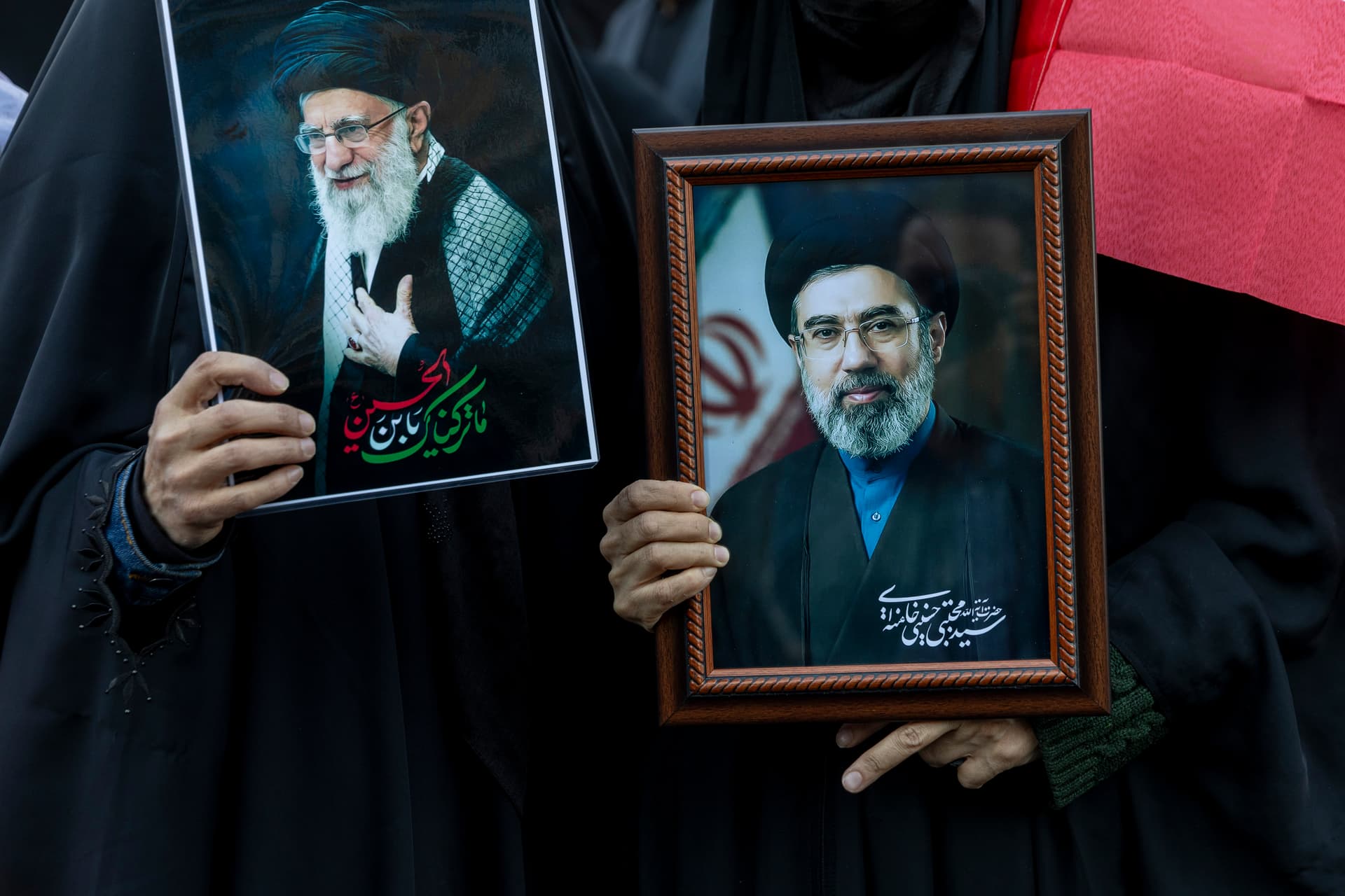 Majid Saeedi/Getty Images Demonstrators hold pictures of Iran's new supreme leader, Ayatollah Mojtaba Khamenei, right, and his father, Ali Khamenei, left, at Tehran's Enghelab Square on March 9, 2026.
