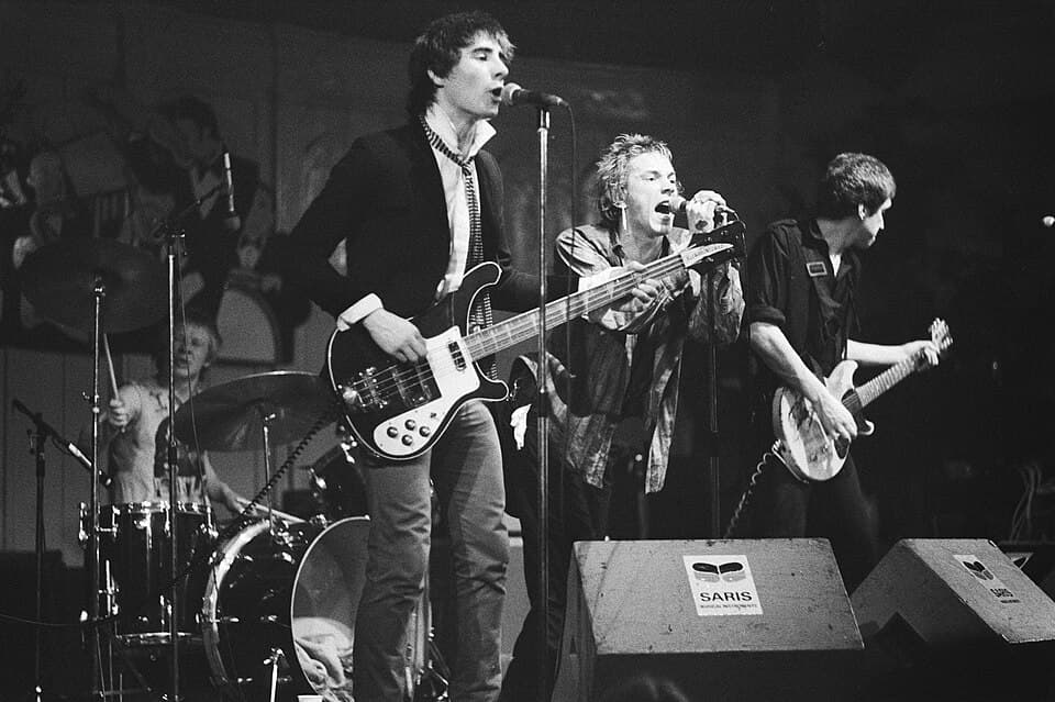 Wikimedia Commons Paul Cook, Glen Matlock, Johnny Rotten, and Steve Jones performing as the Sex Pistols in 1977.