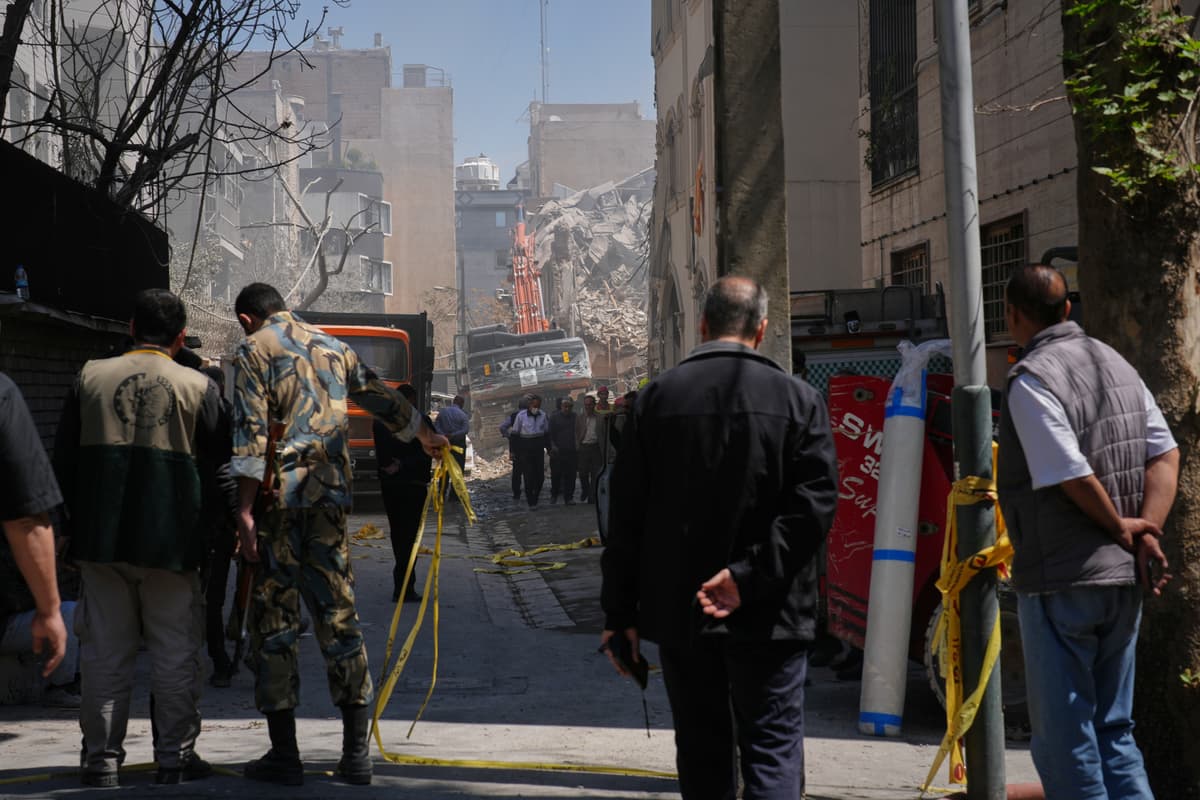 Francisco Seco/AP Bystanders watch as rescue teams work at the site of a strike that, according to a security official at the scene, destroyed half of the Khorasaniha Synagogue and nearby residential buildings in Tehran on April 7, 2026.