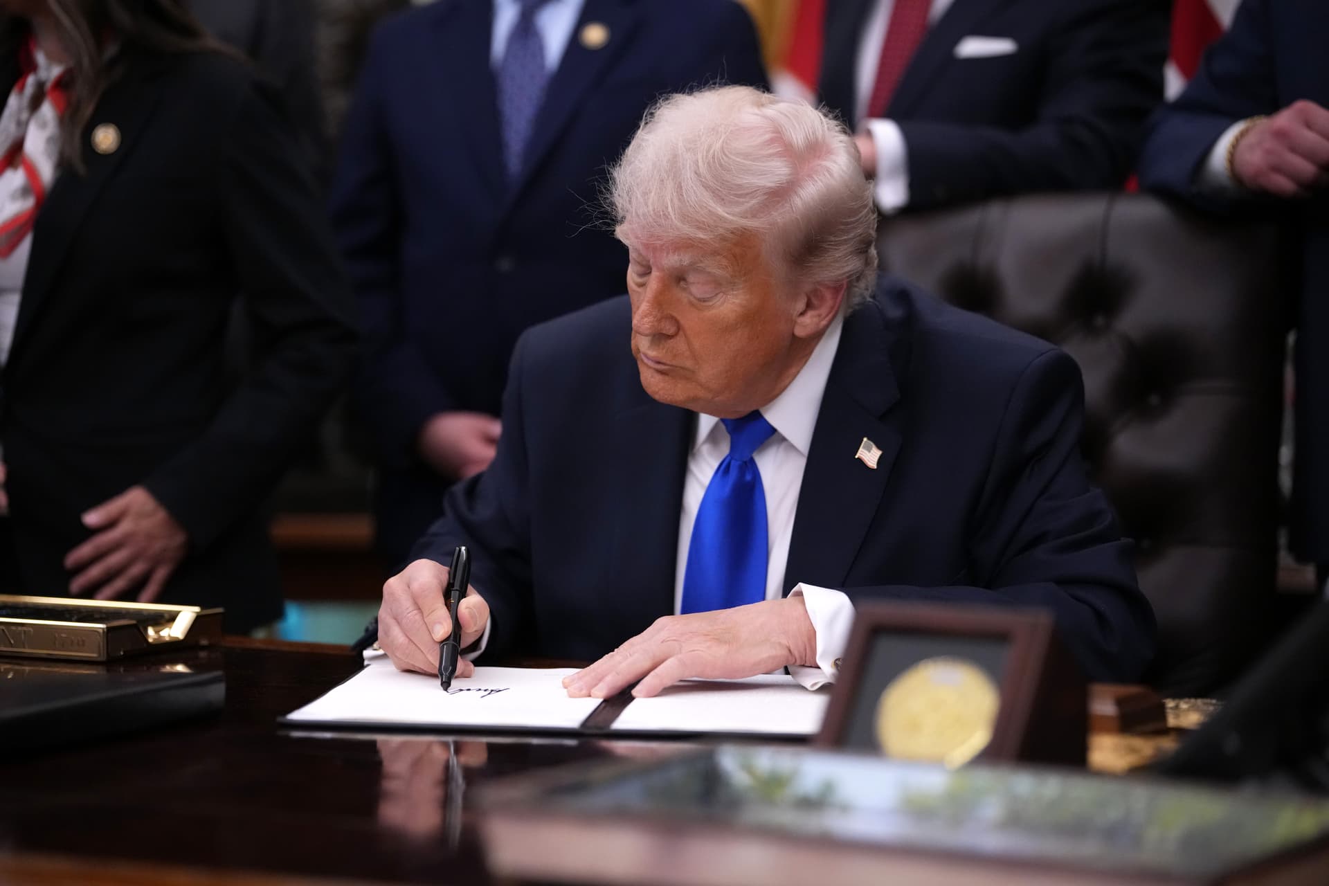 Andrew Harnik/Getty Images President Trump signs an executive order in the Oval Office of the White House on April 30, 2026.