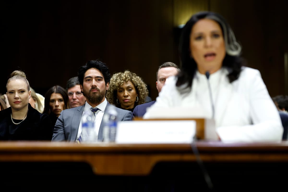 Kevin Dietsch/Getty Images Abraham Williams, husband of Tulsi Gabbard, looks on as she testifies during her confirmation hearing.