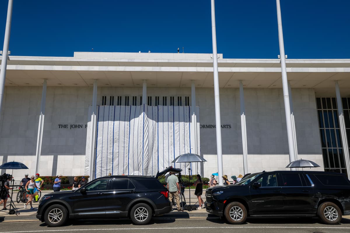 Tasos Katopodis/Getty Images Sight-seers and media gather as tarps are hung on scaffolding outside The Kennedy Center at Washington, D.C., on June 13, 2026.