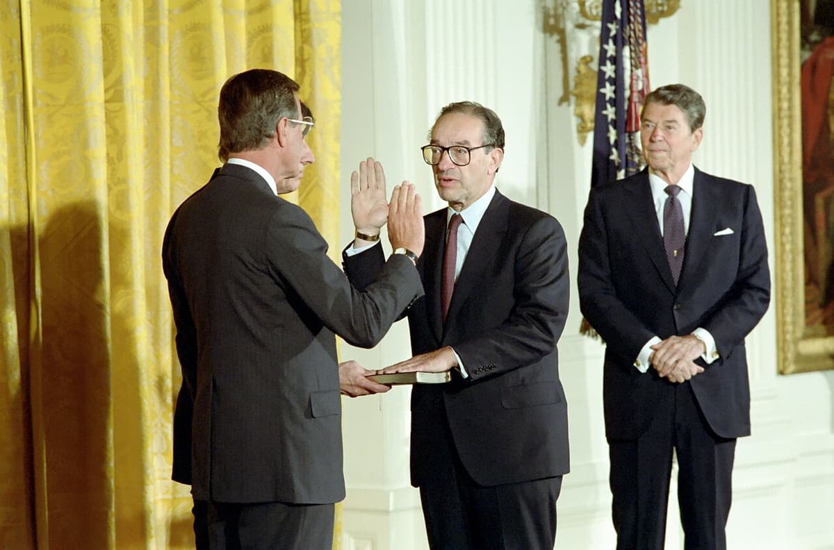 Via Wikimedia Commons President Reagan looks on as Alan Greenspan is sworn in as chairman of the Federal Reserve, August 11, 1987.