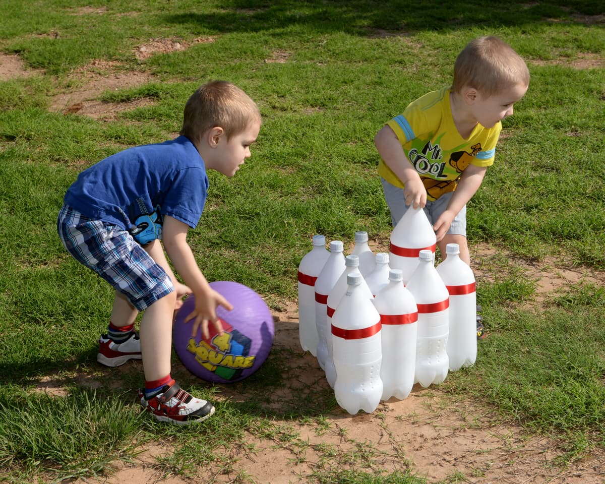 Megan Myhre via DVIDS Children play with soda bottles made of PET.