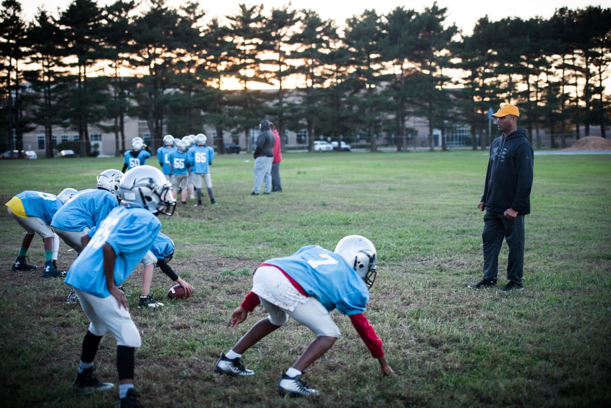 Damien Taylor via DVIDS A football coach supervises practice drills.