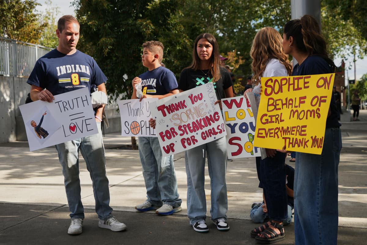 AP/Lindsey Wasson People gather before a WNBA basketball game between the Seattle Storm and the Indiana Fever in support of Fever guard Sophie Cunningham following her comments on transgender athletes, July 28, 2026, at Seattle.