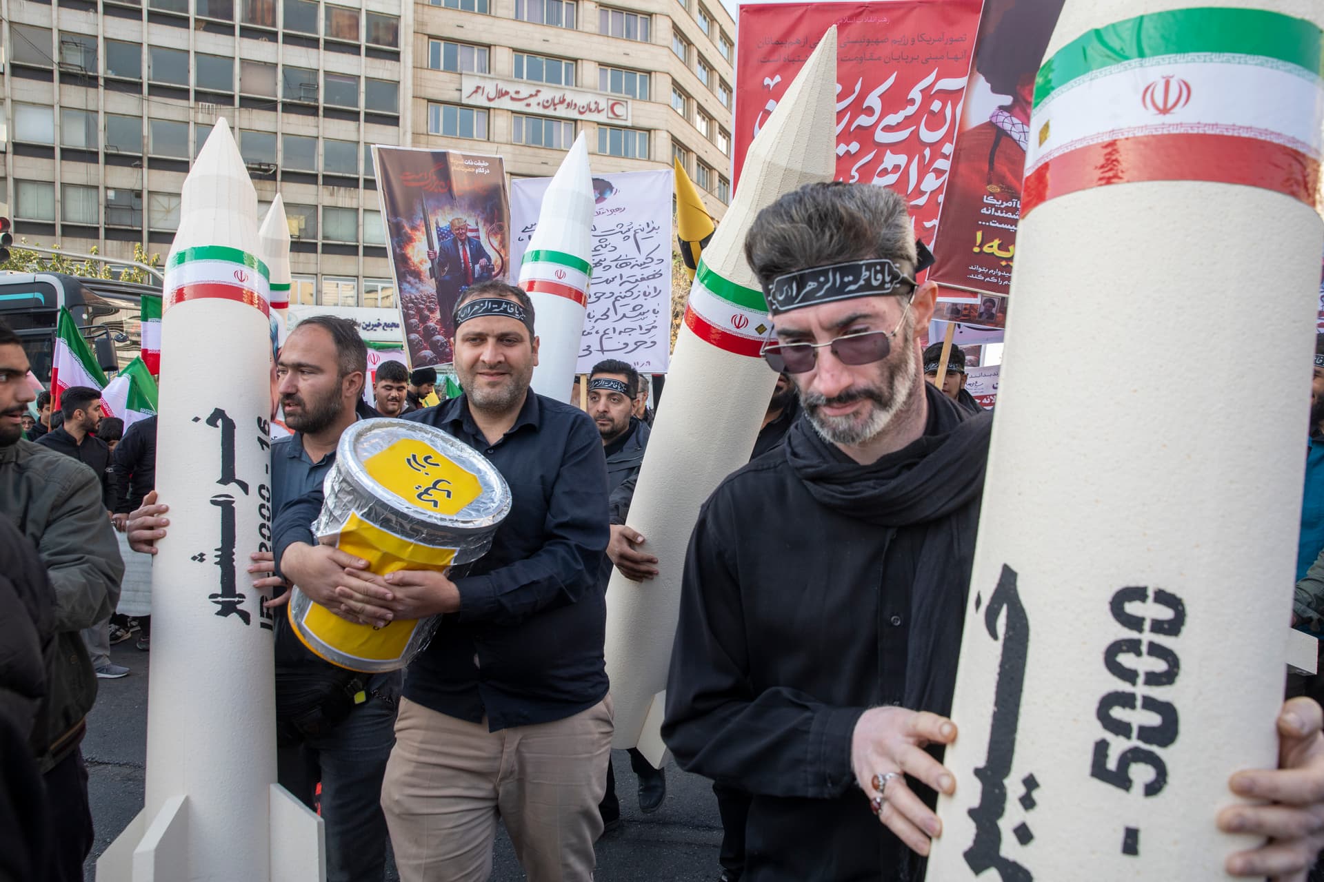 Majid Saeedi/Getty Images Pro-government demonstrators carry mock-ups of Iranian missiles to mark the anniversary of the 1979 American Embassy seizure at Tehran on November 4, 2025.