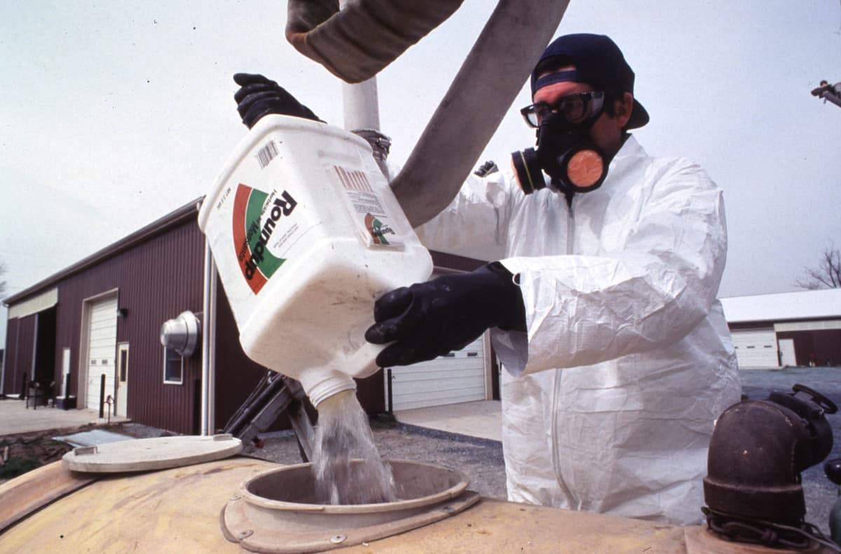 USDA via Getty A farm worker handles Roundup in the American Midwest on August 20, 1999.