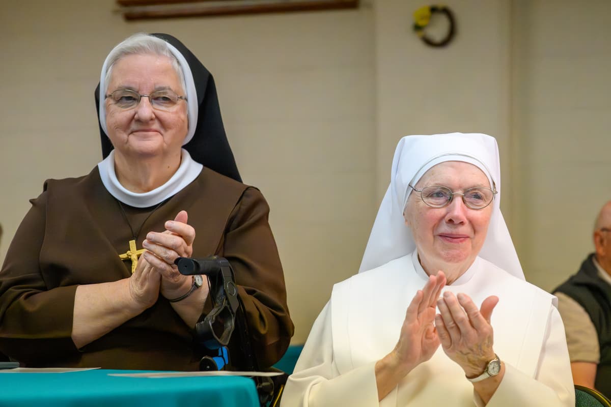Mark Mirko/Connecticut Public via Getty Images Felician Sister Joan Marie Swierzb and Sister Maureen with Little Sisters of the Poor clap during the groundbreaking ceremony for a new affordable housing project at Enfield, Connecticut, on June 3, 2026.
