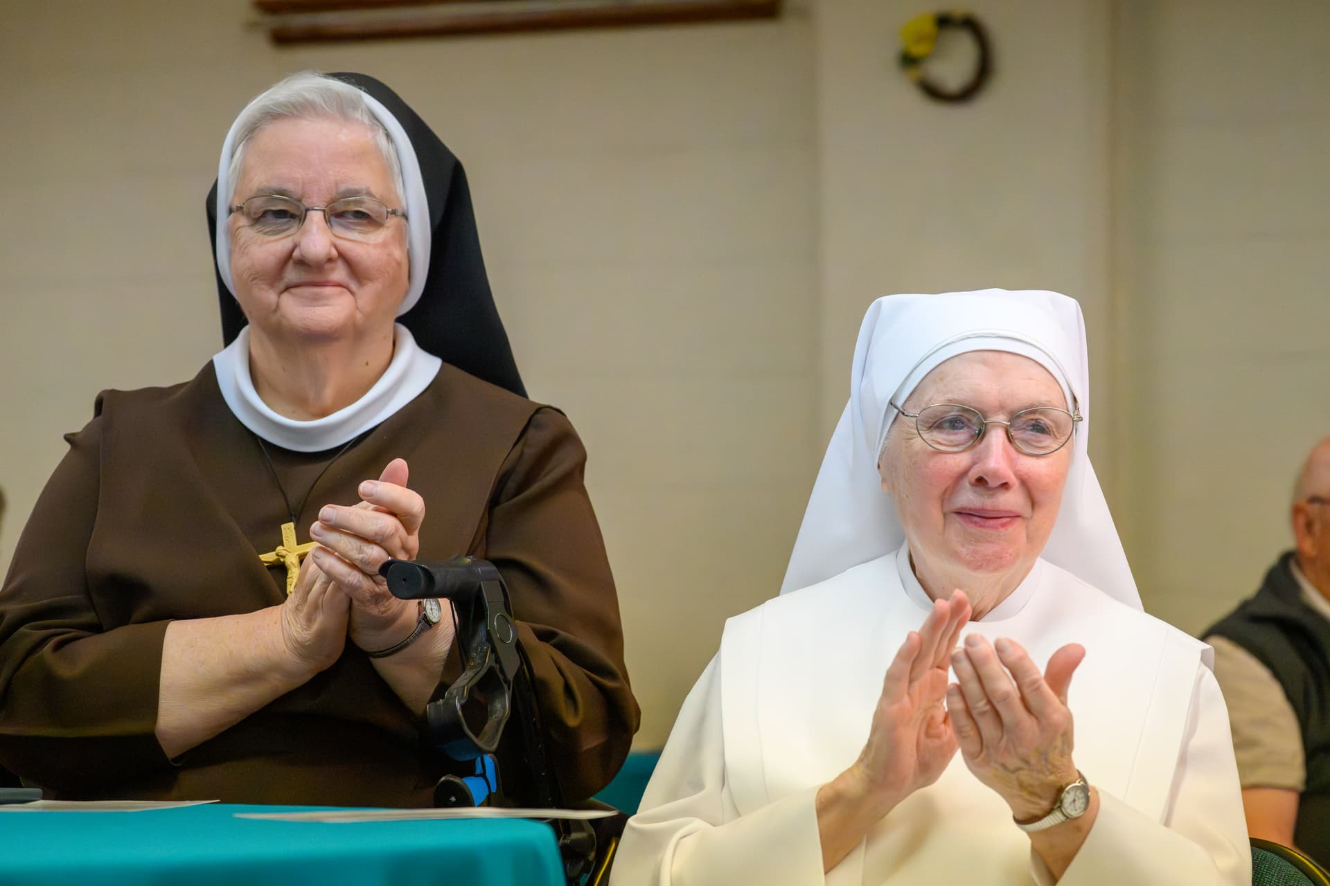 Mark Mirko/Connecticut Public via Getty Images Felician Sister Joan Marie Swierzb and Sister Maureen with Little Sisters of the Poor clap during the groundbreaking ceremony for a new affordable housing project at Enfield, Connecticut, on June 3, 2026.