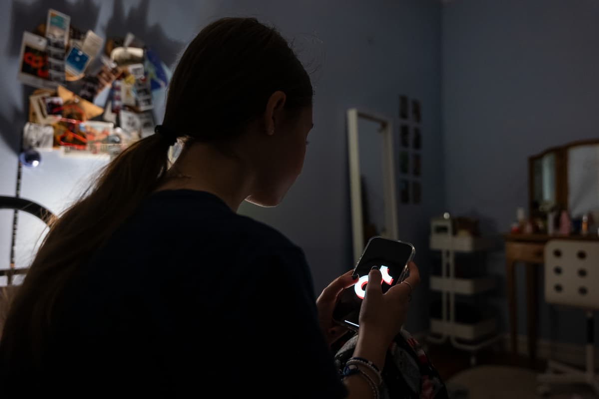 Photo illustration by Spencer Platt/Getty Images A teenager uses her mobile phone to access social media at New York City on January 31, 2024.