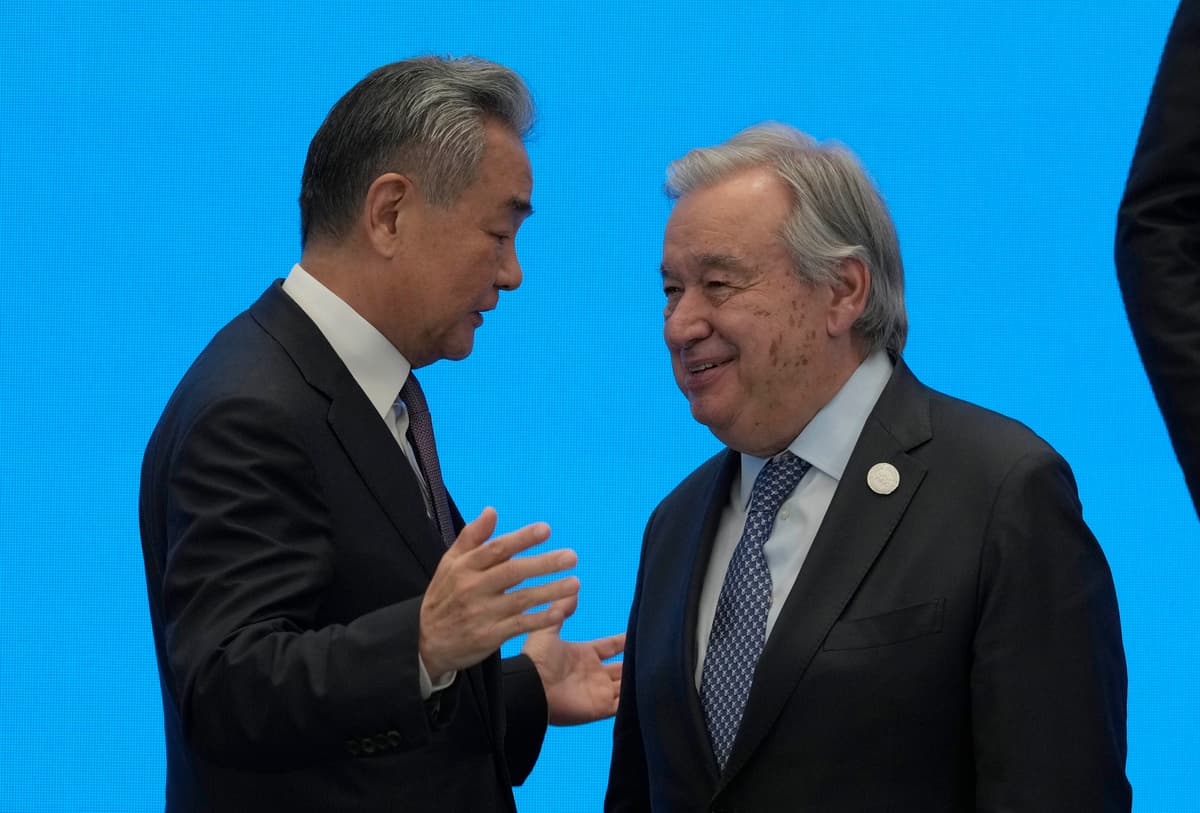 Ng Han Guan-Pool/Getty Images China’s foreign minister, Wang Yi, shakes hands with UN Secretary-General António Guterres on July 16, 2026, ahead of the World AI Conference at Shanghai.