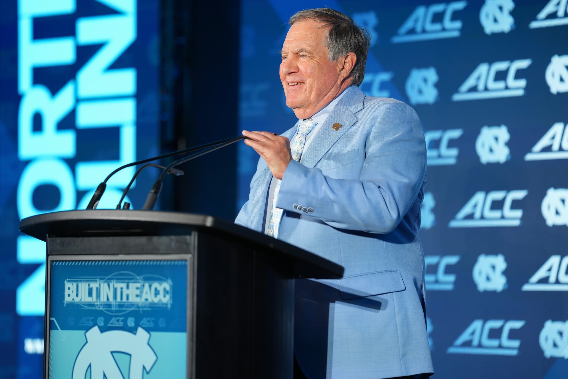 Matt Kelley/Getty Images Head coach Bill Belichick of the North Carolina Tar Heels adjusts the microphone during the ACC Kickoff media days at Charlotte, North Carolina, on July 17, 2026.