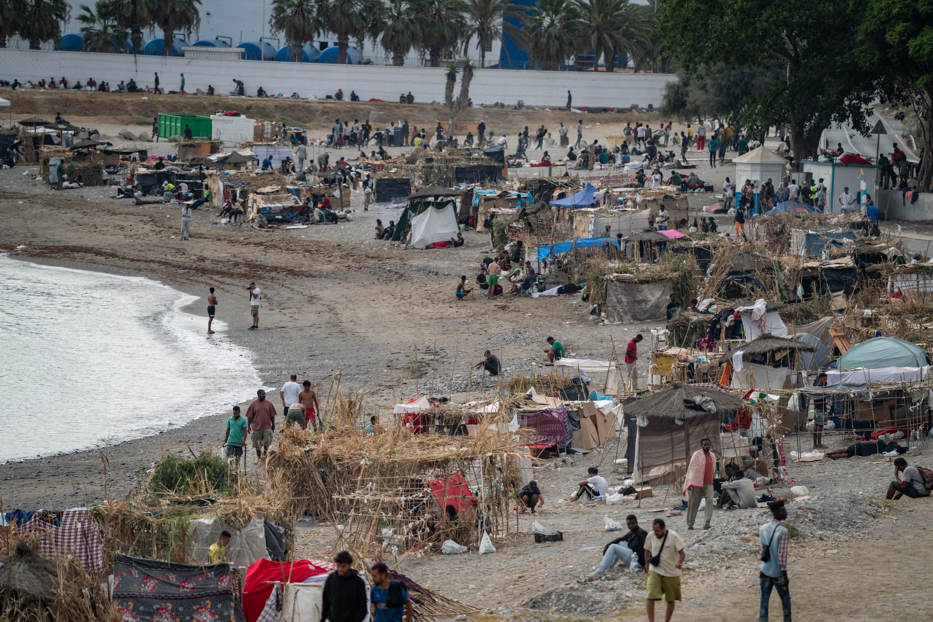 Adri Salido/Getty Images Migrants remain in makeshift shelters on a beach at Ceuta, Spain, on August 16, 2026, two weeks after most of an estimated 78,000 irregular arrivals had returned to Morocco.