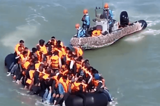 Chris Philp MP via X This still from a video made by an opposition member of the U.K. Parliament shows a French patrol vessel shadowing and apparently assisting a crowded dinghy full of migrants seeking to reach Britain across the English Chanel on July 27, 2026.