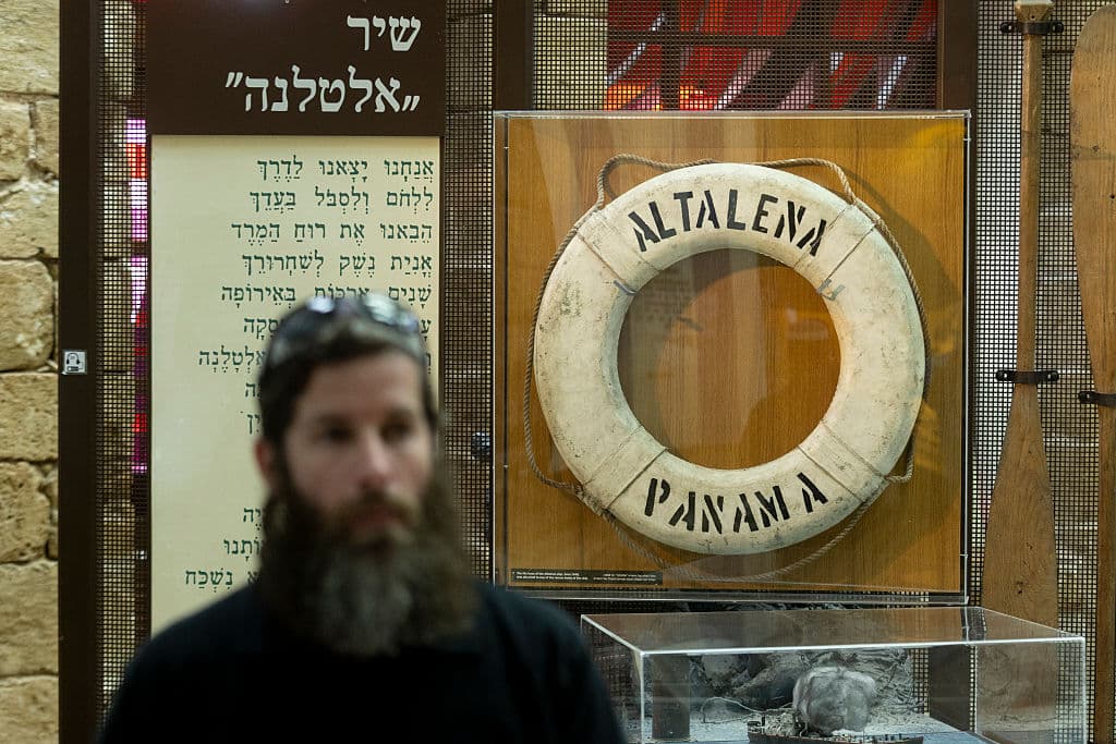 Amir Levy/Getty Images A man passes by an 'Altalena' exhibition at the Etzel Museum following the discovery of the Altalena ship after 78 years at bottom of the Mediterranean sea on August 24, 2026 at Tel Aviv, Israel.