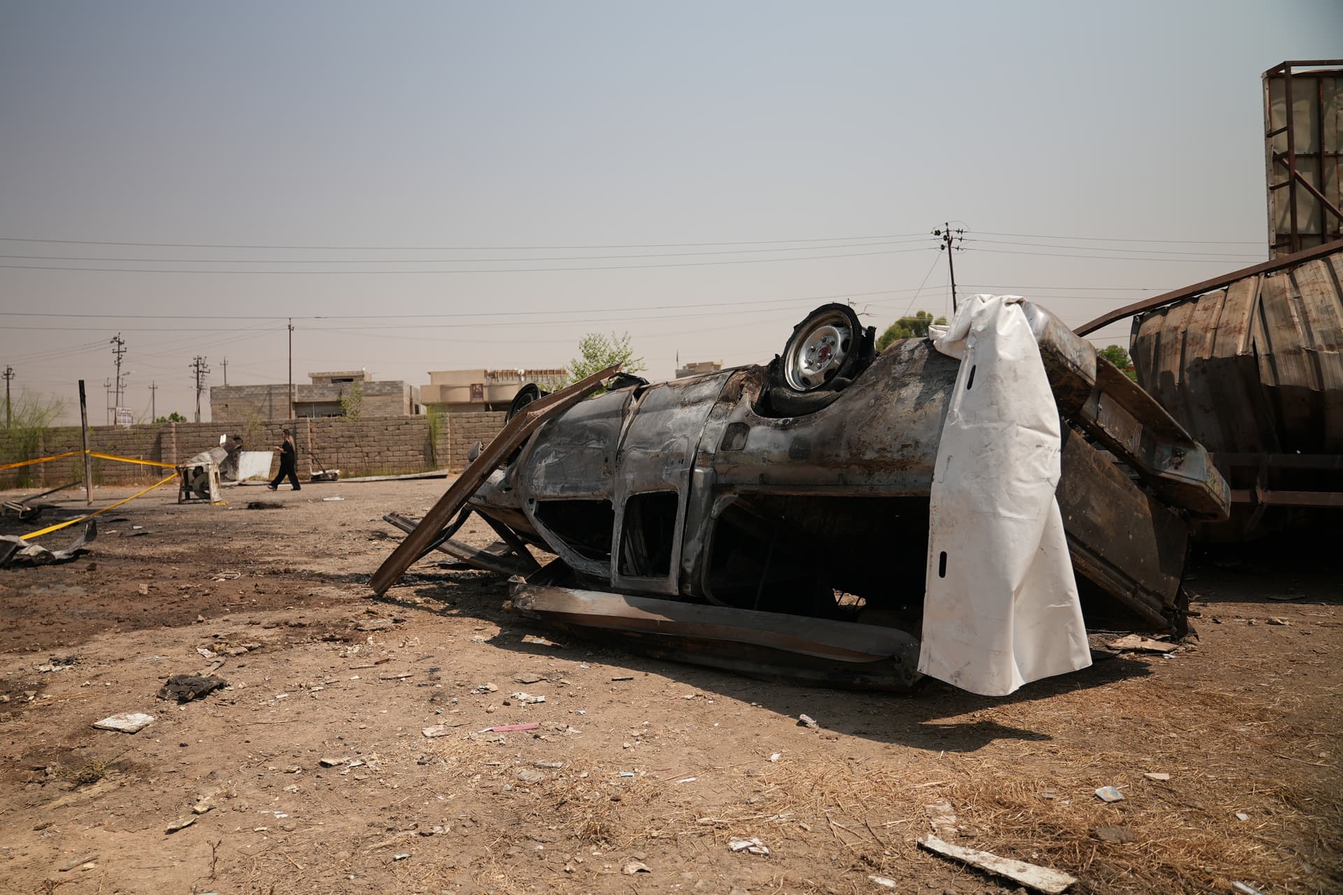 Farid Abdulwahed/AP A damaged vehicle sits at the site of an airstrike on a Popular Mobilization Forces base at Mosul, Iraq, on July 29, 2026.