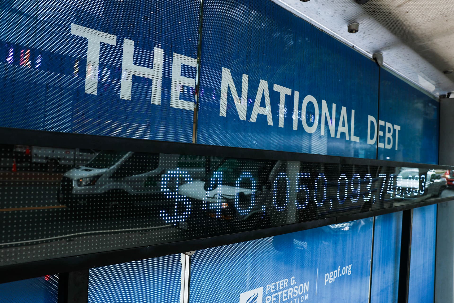Anna Moneymaker/Getty Images A sign displays the national debt on a bus stop on August 20, 2026 at Washington, D.C.