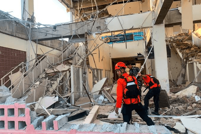 Indonesian National Search and Rescue Agency via X Rescue workers search through what remains of the passenger waiting room at Laurentius Say Port at Maumere on Flores Island, Indonesia, after a 7.7 magnitude earthquake on August 15, 2026.
