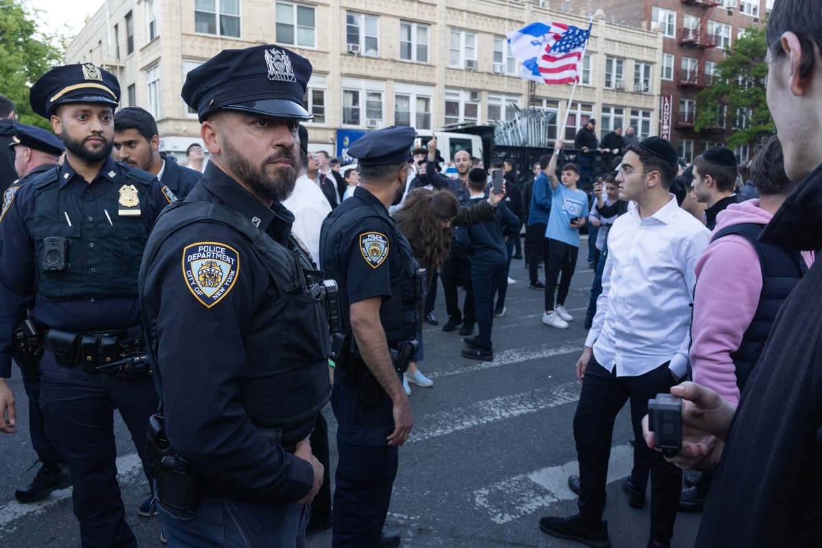 Andrew Lichtenstein/Corbis via Getty Images Police and protesters on May 11, 2026 outside a synagogue at the Midwood neighborhood of Brooklyn, New York City.