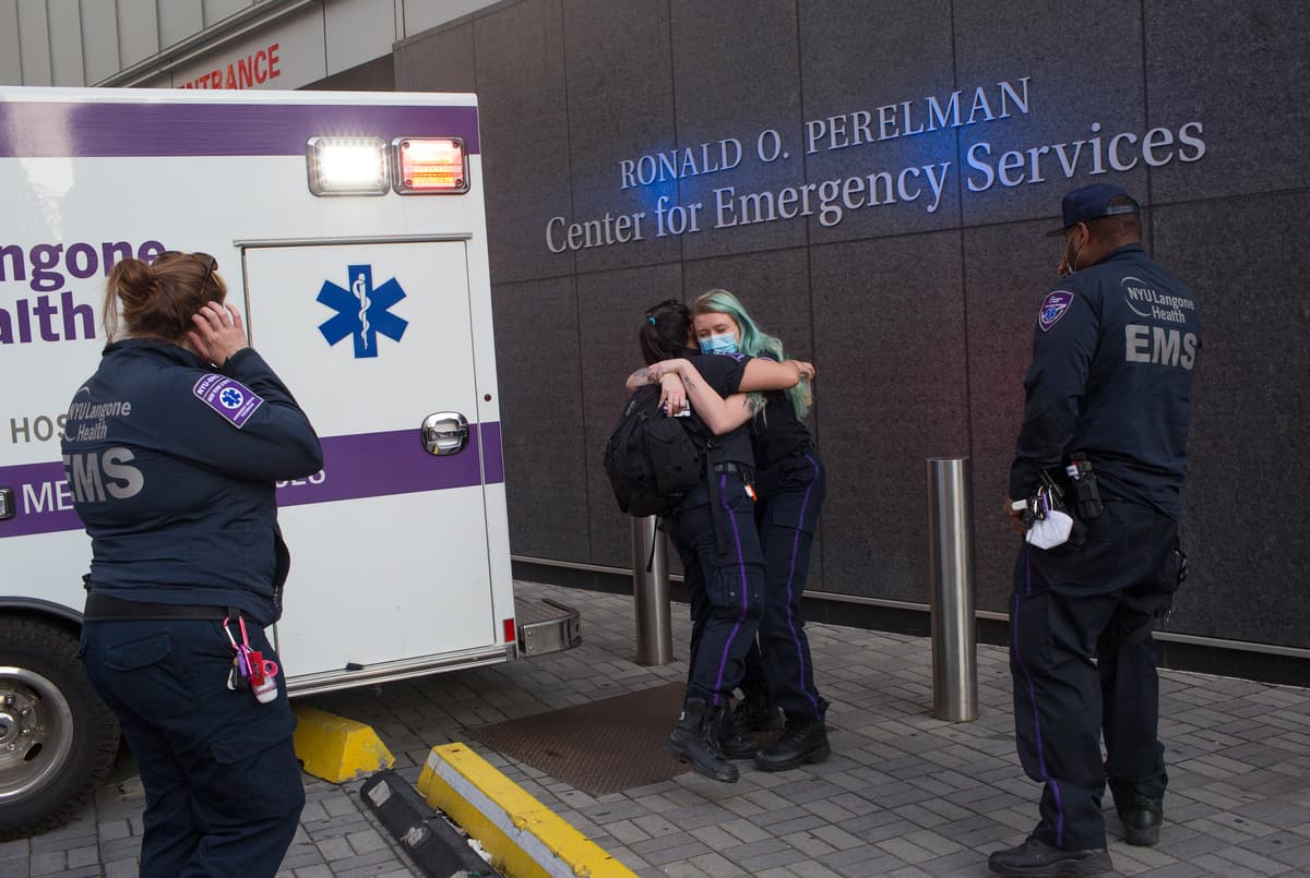 Andrew Lichtenstein/Corbis via Getty Images EMT paramedics hug outside the emergency room of NYU's Langone Hospital at New York CIty.