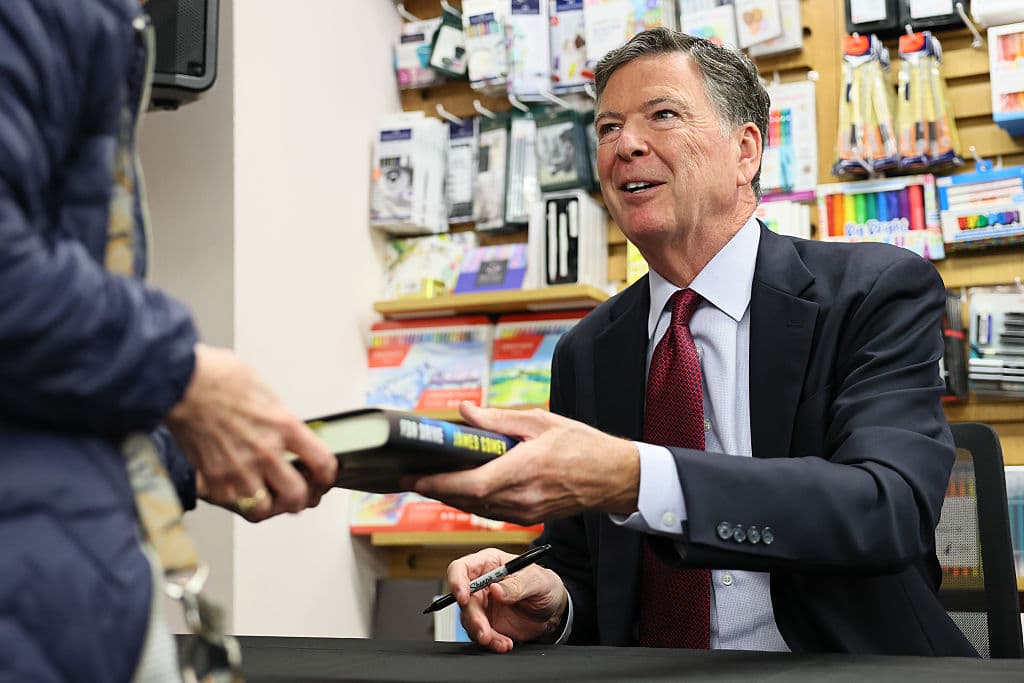 Michael M. Santiago/Getty Images James Comey signs copies of his books on May 19, 2025 at New York City.