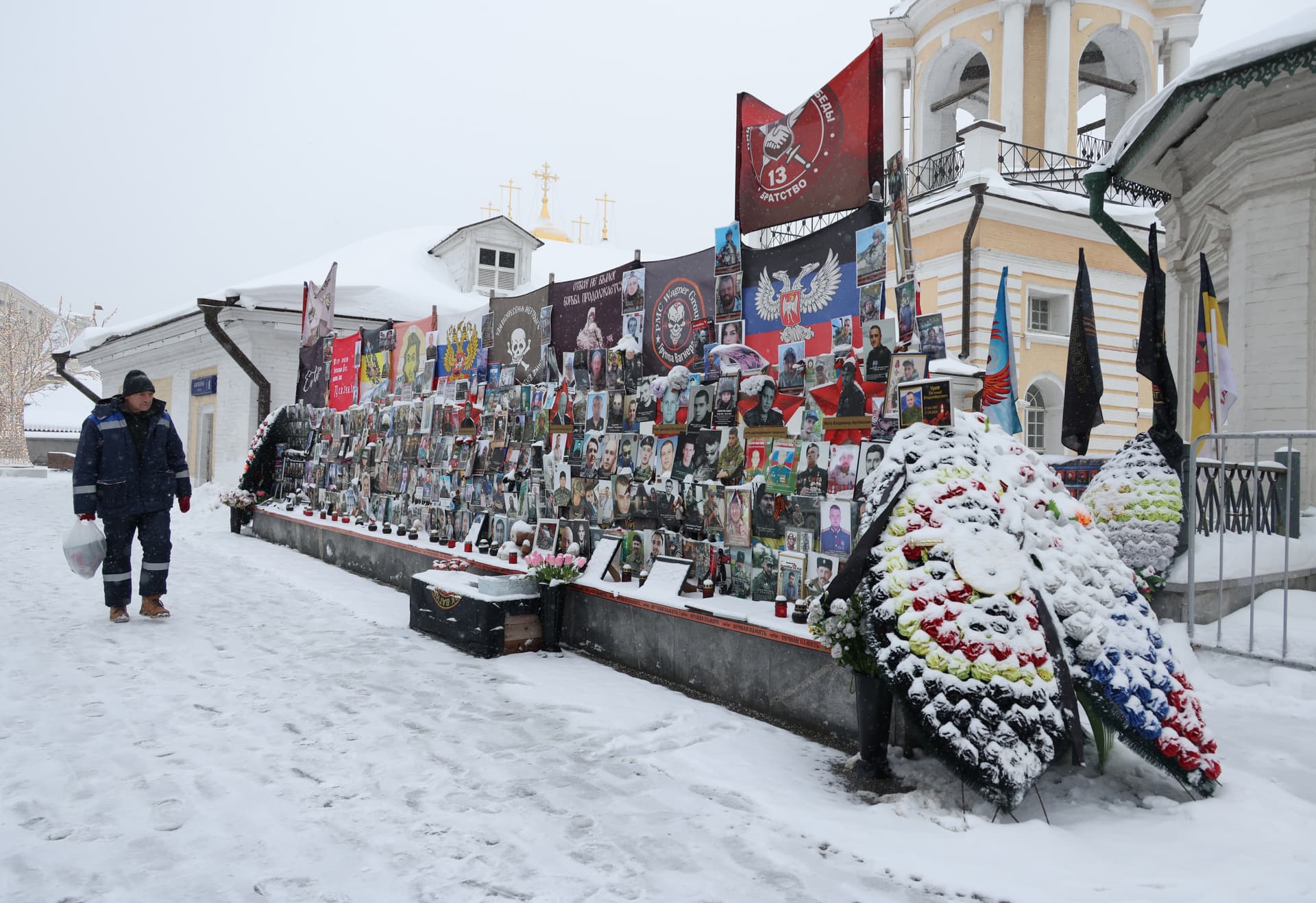 Contributor/Getty Images A man looks at an informal memorial to Russian participants of the military invasion of Ukraine at Varvarka street near the Kremlin.