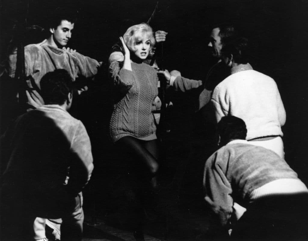 L J Willinger/Getty Images) Marilyn Monroe talking to the Jack Cole dancers between takes on the set of 1960's 'Let's Make Love'.
