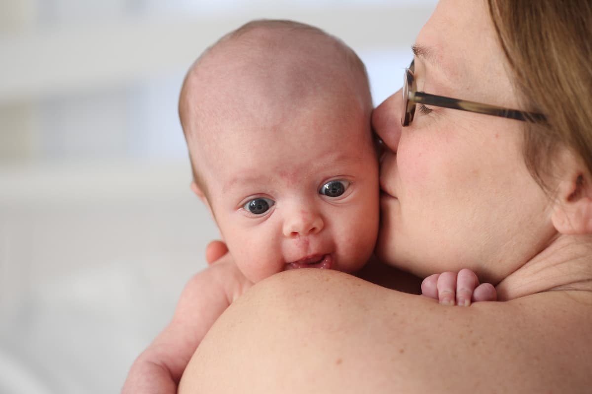 Tim Clayton/Corbis via Getty Images A two month old baby girl rests on the shoulder of her mother.