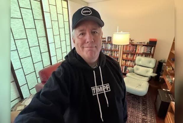 Andrew Wimsatt displays TMPF gear in a selfie sent to television personality Kat Timpf in late 2025. Andrew Wimsatt displays TMPF gear in a selfie sent to television personality Kat Timpf in late 2025.