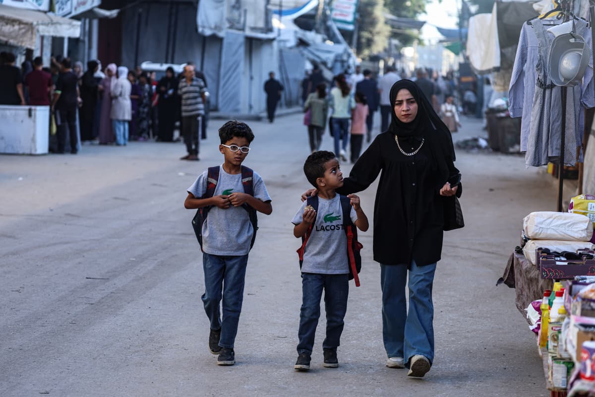Omar Ashtawy/Getty Images A mother walks her sons to a UNRWA-run school at a displaced persons camp at central Gaza on September 19, 2026.