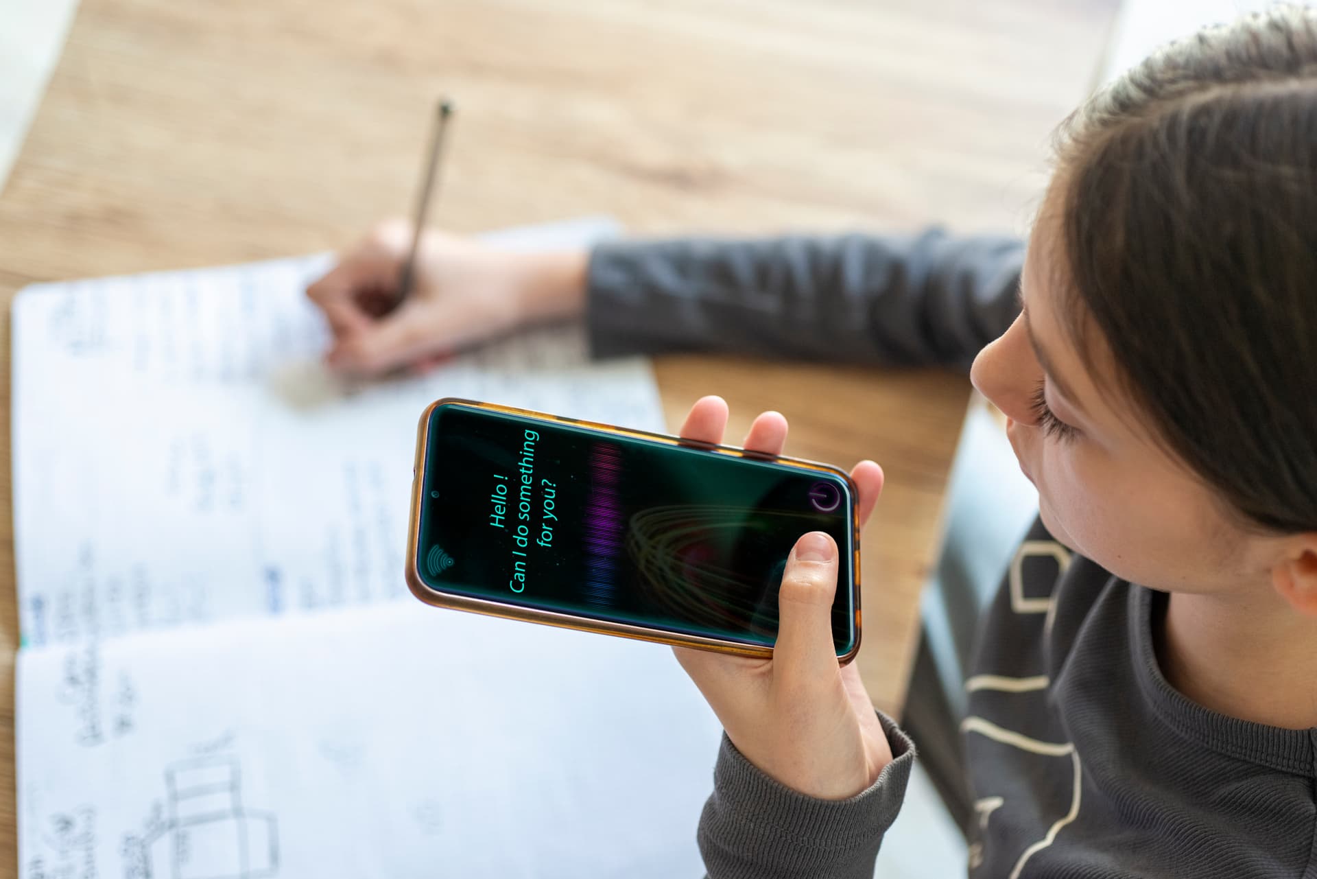 Getty Images. Young girl uses AI virtual assistant to do schoolwork.Concept of Artificial Intelligence and Futuristic technology