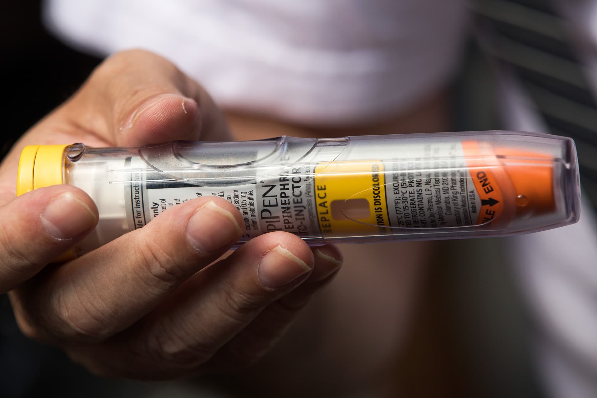 Drew Angerer/Getty Images Timothy Lunceford Stevens, who suffers from autoimmune diseases and allergies, holds an EpiPen.