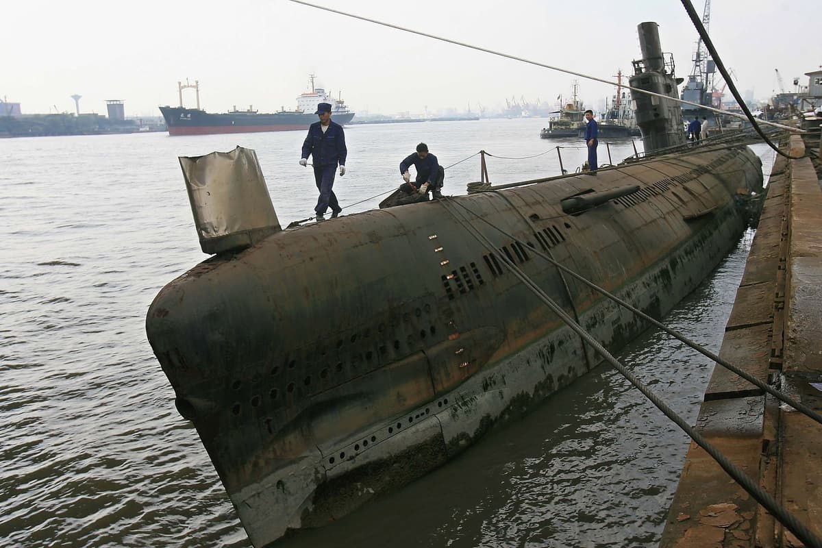 Getty Images Chinese workers labour atop a retired submarine at a dock of the Jiangnan Shipyard on October 23, 2006 at Shanghai, China.