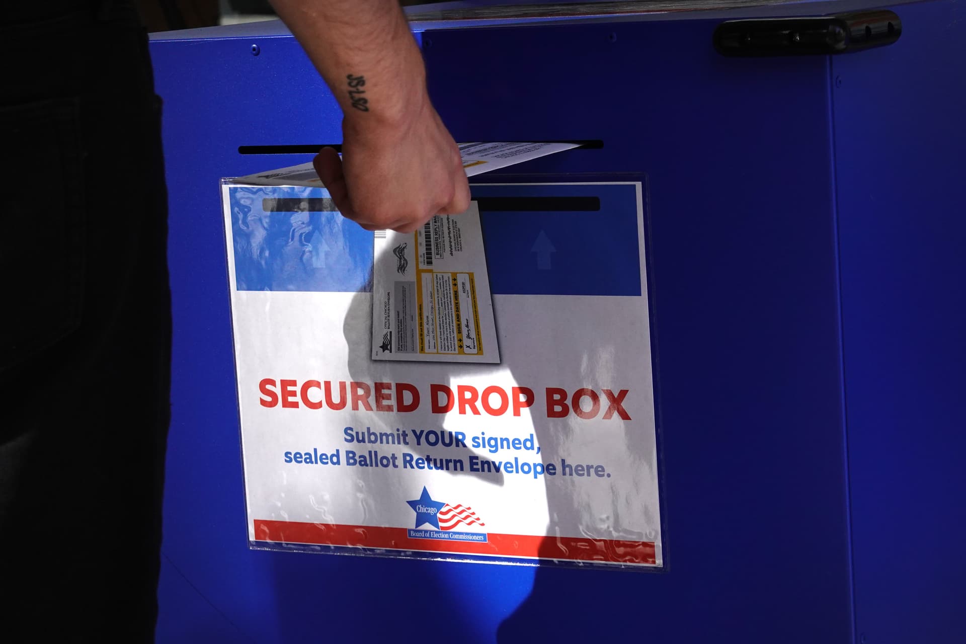 Scott Olson/Getty Images A voter drops off a ballot at Chicago.