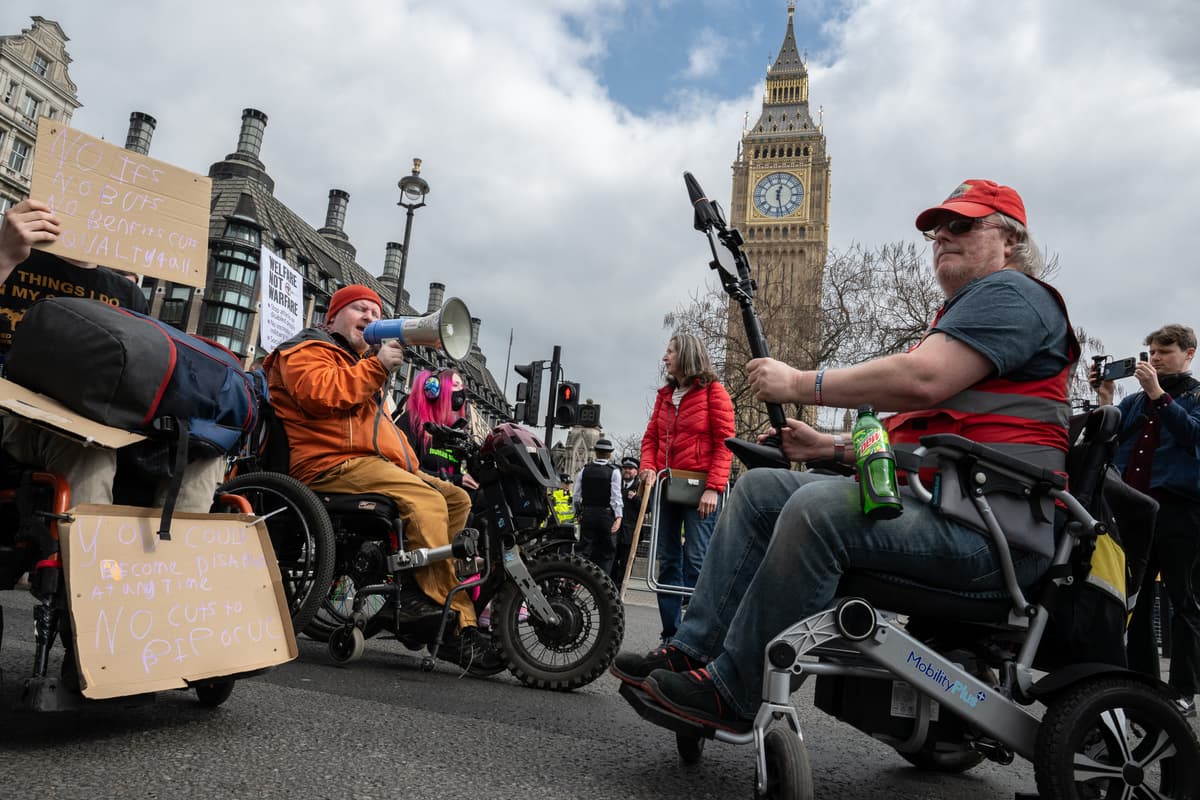 Guy Smallman/Getty Images Disabled activists protest outside Parliament on March 26, 2025 at London.