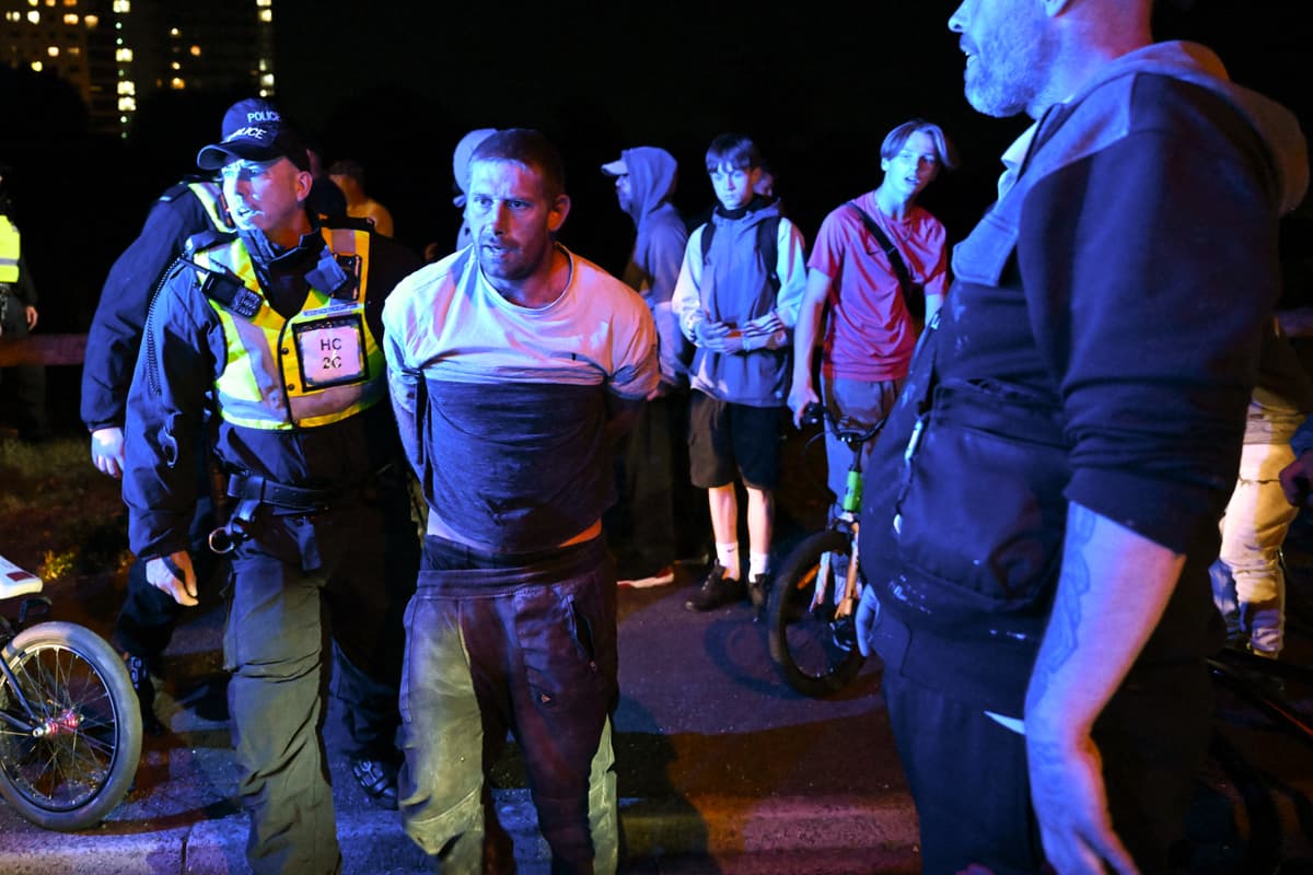 Finnbarr Webster/Getty Images A protester against lax migration policies is handcuffed on September 22, 2026 at Gosport, England.